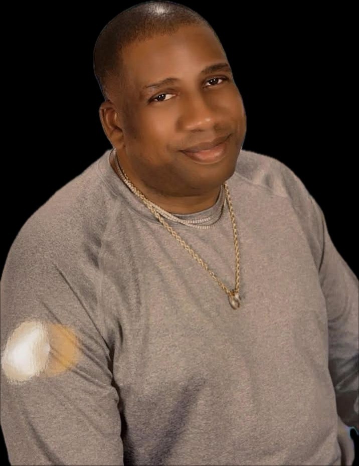 Close-up Portrait of a Man Wearing a Gold Chain and a Black Shirt