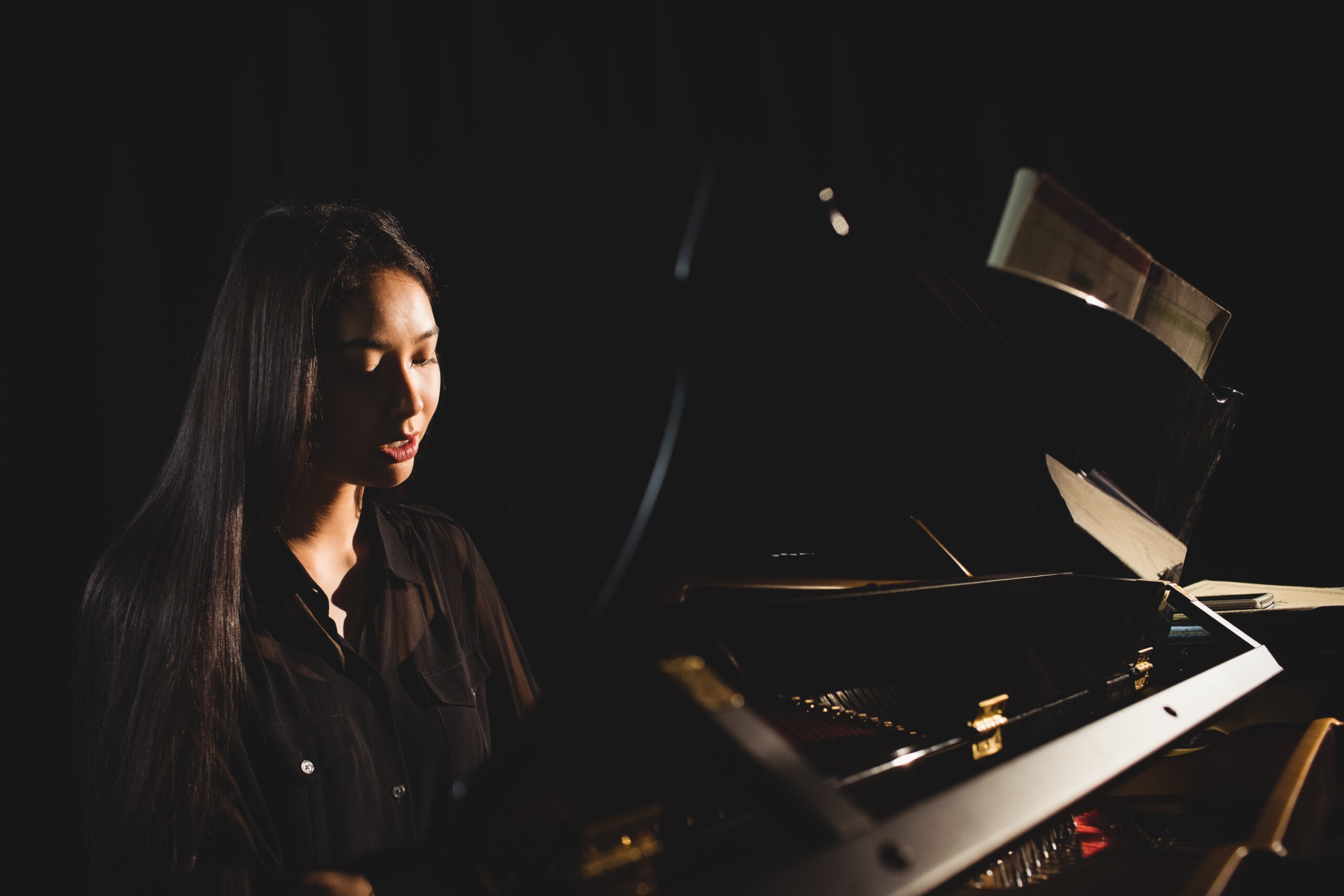 Female Student Playing Piano in a Studio